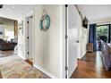 Hallway with wood flooring, a beachy decor, and access to multiple rooms and a back deck at 601 Magnolia Ln, Edisto Island, SC 29438