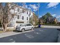 Exterior shot of a two story home with light blue siding next to a silver SUV at 757 King St, Charleston, SC 29403
