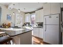 Bright kitchen features white cabinets, stainless steel appliances, and a breakfast bar at 757 King St, Charleston, SC 29403
