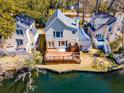 Aerial view of a waterfront property with a spacious wooden deck, perfect for enjoying outdoor living and stunning views at 777 Lake Frances Dr, Charleston, SC 29412