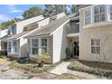 Charming home with a well-maintained yard and a balcony above the doorway at 8 Townpark Ln # B, Charleston, SC 29412