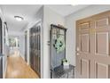 Welcoming foyer featuring hardwood floors and neutral gray wall paint at 8 Townpark Ln # B, Charleston, SC 29412