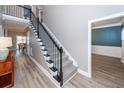Elegant staircase with carpeted steps and stylish black metal railings, open floor plan at 8745 Alexandria Dr, North Charleston, SC 29420