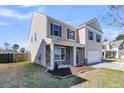 Attractive two-story home with stone accents and neutral siding complemented by a green lawn and blue sky at 105 Endicott Ct, Summerville, SC 29486