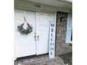 Welcoming front entryway with double doors, decorative wreath, and brick accents enhance curb appeal at 106 Shirley Dr, Ladson, SC 29456