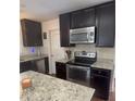 Modern kitchen features stainless steel appliances, granite countertops, and ample cabinet space at 106 Shirley Dr, Ladson, SC 29456