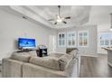 Bright living room featuring a trey ceiling, hardwood floors, and an open layout at 139 Ancestry Ln, Moncks Corner, SC 29461