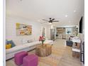 Bright living room featuring modern decor, shiplap walls, and an open layout connecting to the kitchen at 1605 Evergreen St, Charleston, SC 29407
