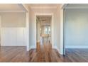 Bright hallway showcasing hardwood floors, wainscoting, and views into adjacent rooms with white trim at 1625 Oak Leaf St, Daniel Island, SC 29492