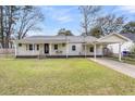 Charming single-story home with a well-manicured lawn and covered parking at 1723 River Front Dr, Charleston, SC 29407