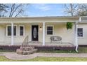 Welcoming front porch with brick steps, decorative columns, and charming seating at 1723 River Front Dr, Charleston, SC 29407