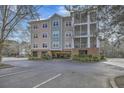 Attractive condo building with covered parking, multiple stories, and balconies at 1755 Central Park Rd # 7203, Charleston, SC 29412
