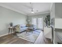 Well-lit living room offers a comfortable seating area and a view of the balcony at 1755 Central Park Rd # 7203, Charleston, SC 29412