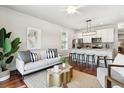 Open-concept living room featuring stylish furniture, modern decor, and an eat-in kitchen with bar seating at 1981 Central Park Rd, Charleston, SC 29412