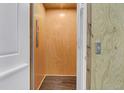 Private residential elevator with wood interior and contrasting wood grain flooring at 2032 Amenity Park Dr, Mount Pleasant, SC 29466