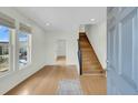 Bright entryway with gleaming hardwood floors, stairs, and neutral paint colors at 2097 Mt Pleasant St, Charleston, SC 29403