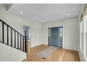 Welcoming foyer features hardwood floors, modern lighting, and an entry door with sidelights at 2097 Mt Pleasant St, Charleston, SC 29403