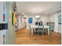 Bright dining room featuring hardwood floors, a modern chandelier, and a view into the hallway at 2115 Wappoo Dr, Charleston, SC 29412