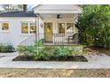 A welcoming front porch features decorative railings and fresh landscaping, enhancing curb appeal at 2115 Wappoo Dr, Charleston, SC 29412