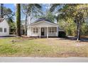 Charming one-story home with a front porch and well-manicured lawn, creating a welcoming curb appeal at 25 Oak Forest Dr, Charleston, SC 29407
