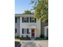 A charming two-story townhome featuring a red door, black shutters, and a well-maintained landscape at 303 Lakeside Dr # C-2, Mount Pleasant, SC 29464