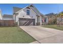 Well-maintained single-Gathering home with a spacious driveway and manicured front lawn at 311 Citation Way, Moncks Corner, SC 29461