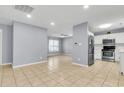 Open living area with tile floors, natural light and flows into the kitchen for easy entertaining at 3316 Island Estates Dr, Johns Island, SC 29455