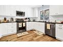 Well-lit kitchen with white cabinets, stainless steel appliances, and sleek countertops at 3323 Myrtle St, Edisto Island, SC 29438