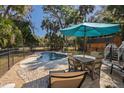 Inviting backyard pool area featuring a patio, lounge chairs, and lush tropical landscaping at 3323 Myrtle St, Edisto Island, SC 29438