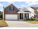 Beautiful brick home with a well-manicured lawn, two-car garage, and inviting covered porch at 3707 Blackjack Rd, Ladson, SC 29456