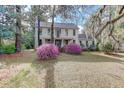 Charming two-story home with mature trees and beautifully landscaped front yard at 408 N Parler Ave, Saint George, SC 29477