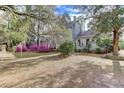 Landscaped yard featuring flowering shrubs and mature trees provide shade and privacy at 408 N Parler Ave, Saint George, SC 29477