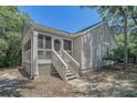 Exterior with screened porch, decorative front door, and low-maintenance yard at 433 Double Eagle Trace, Seabrook Island, SC 29455