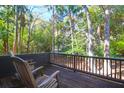Outdoor balcony features wooden rocking chairs, dark railings, and plenty of shade at 4901 Green Dolphin Way, Kiawah Island, SC 29455