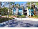 Stylish condo with teal siding, sidewalks, palm trees, and convenient parking at 4901 Green Dolphin Way, Kiawah Island, SC 29455