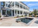 Charming backyard with a refreshing pool, patio seating, and beautifully landscaped garden at 5 Alexander St, Charleston, SC 29401