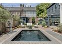 Private backyard oasis featuring a stylish pool, comfortable seating, and meticulously maintained landscaping at 5 Alexander St, Charleston, SC 29401