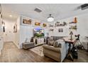 Comfortable living room with couch, television, decorative shelving, and stylish decor at 509 Nadir Ct, Summerville, SC 29486