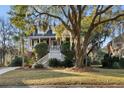 Charming brick home with a inviting double staircase and landscaped front yard, showcasing Southern elegance at 669 Palisades Dr, Mount Pleasant, SC 29464