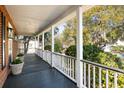 Spacious porch with dark-stained wood flooring and white columns providing an outdoor retreat at 669 Palisades Dr, Mount Pleasant, SC 29464