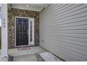Close-up of the front door featuring brick accents, a welcome mat, and the house number prominently displayed at 762 Redbud Ln, Summerville, SC 29486