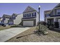 A well-maintained home showcasing a two-car garage, brick accents, and a well-manicured front lawn at 762 Redbud Ln, Summerville, SC 29486