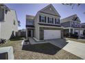 View of a two-story residence with brick and siding, a two-car garage, and a walkway to the front door at 762 Redbud Ln, Summerville, SC 29486
