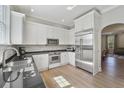 Modern kitchen featuring white cabinets, stainless steel appliances, and a stylish countertop at 871 Center Park St, Charleston, SC 29492