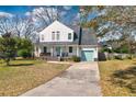 Charming two-story home with a welcoming front porch and a well-manicured lawn at 960 Mooring Dr, Charleston, SC 29412