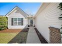 Inviting front entrance with well-maintained landscaping, white siding, and a welcoming walkway at 103 Old Tree Rd, Goose Creek, SC 29445