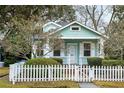 Charming home exterior featuring a picket fence, tidy landscaping, and a cozy covered porch at 103 Tall Oak Ave, Charleston, SC 29407