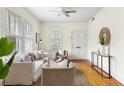 Inviting living room featuring hardwood floors, neutral furniture, and bright, natural light at 103 Tall Oak Ave, Charleston, SC 29407