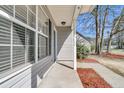 Inviting front porch of a cozy home, featuring classic columns and manicured landscaping at 106 Equestrian Ct, Summerville, SC 29486