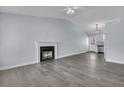 Bright living room with a fireplace, high ceiling, and modern gray flooring at 106 Equestrian Ct, Summerville, SC 29486